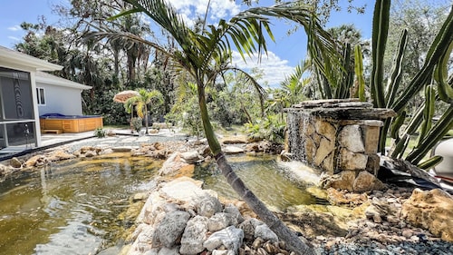 Tropical Home With Waterfall, HotTub, Fenced Yard, Beachy Lounge Area & Pets!