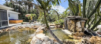 Tropical Home With Waterfall, HotTub, Fenced Yard, Beachy Lounge Area & Pets!