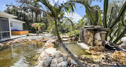 Tropical Home With Waterfall, HotTub, Fenced Yard, Beachy Lounge Area & Pets!