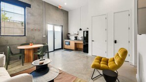 A modern interior with a dining area, a kitchen, and a living space. - Claudia - Unit 4 | Sense of Calm and Relaxation, Walking Distance to the Excitem (New Orleans)