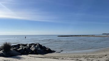 Enjoy a tranquil beach experience with calm waters and a clear view.