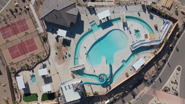 An aerial view of a resort with a large swimming pool, tennis courts, and a water slide. - Paseos to Redrocks, HUGE REC ROOM! PICKLEBALL! (Washington)
