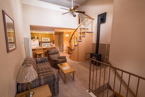 Relax in a cozy space with a sofa, armchair, and kitchenette.