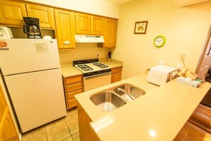 Enjoy cooking in this well-equipped kitchen with a gas stove, sink, and appliances.
