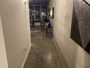 Stylish hallway leads to a dining area with a table and chairs.