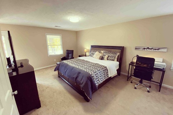 Master with King bed, en suite bathroom, and office area.