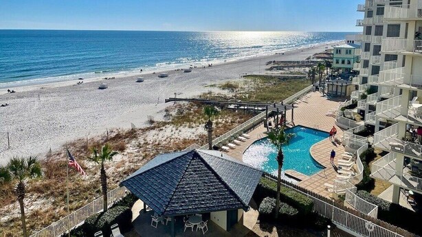 A beachfront hotel with a swimming pool, beach access, and a view of the ocean. - Windward Pointe 604 | Spacious, Update, Beach Front! (Orange Beach)