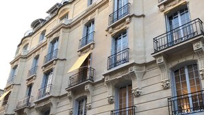 A multi-story building with ornate architectural details, including decorative moldings and balconies with wrought iron railings. - 200m2 luxury apartment in a secure private alley. Center of Paris (PARIS)