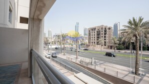 A balcony with a view of a cityscape, including tall buildings and palm trees. - Holidays R Us villa 3 bedroom premium location (Dubai)