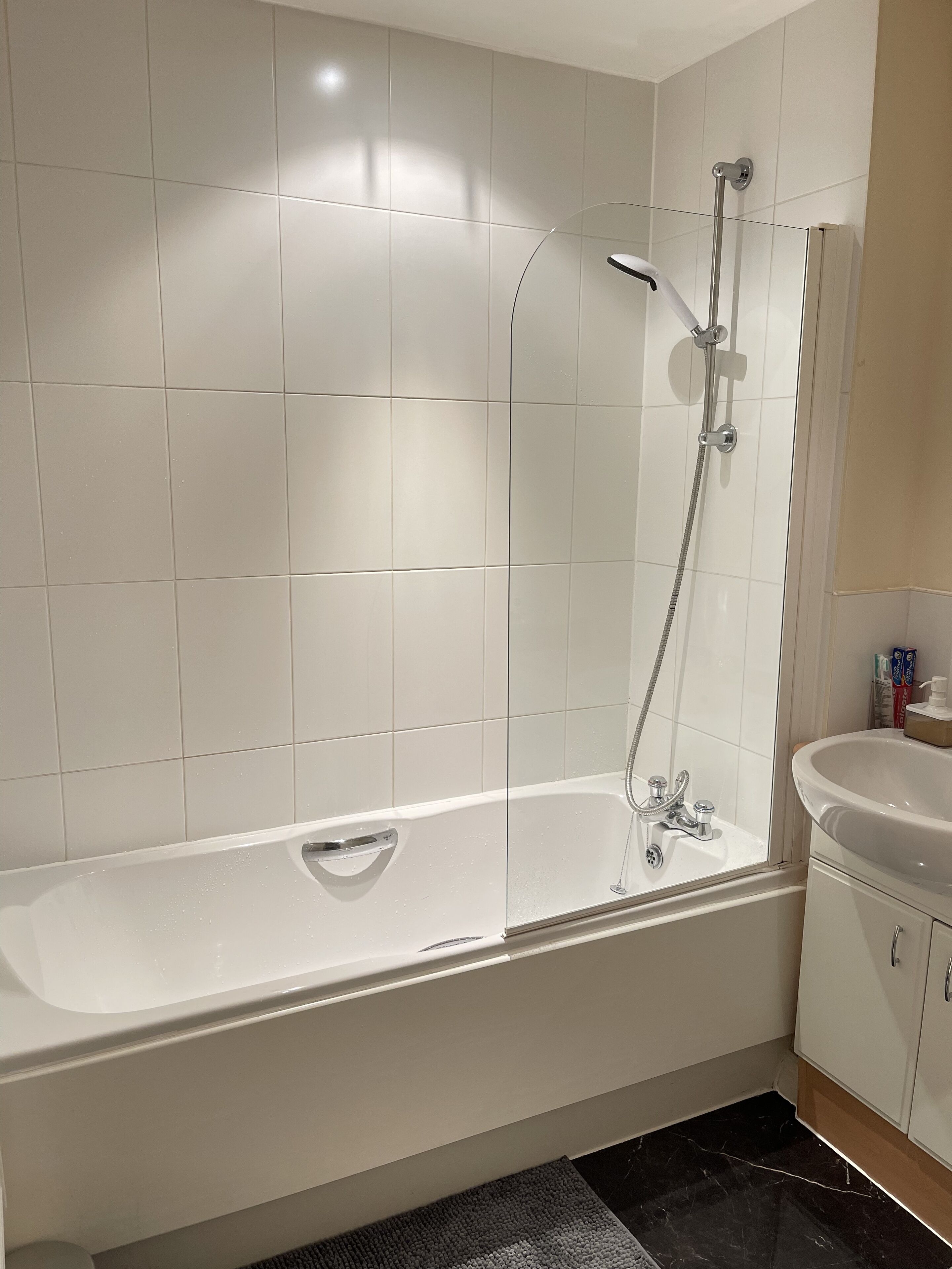 Combined shower/bathtub, towels, soap, toilet paper