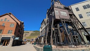 A multi-story building with a unique architectural design, featuring a prominent tower structure and multiple windows. - Updated Townhome | Private Hot Tub | Pool access (Keystone)