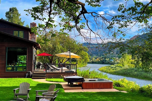 This home boasts front-row river views and direct access to Roaring Fork River.