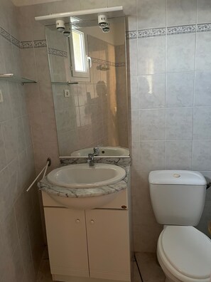 A bathroom with a marble sink, a toilet, and a glass shower enclosure. - House (Poggio-d'Oletta)