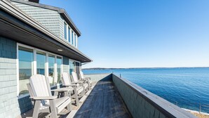 A wooden deck with Adirondack chairs overlooking a body of water. - Sunrise Catcher with a Panoramic View!  (Harpswell)