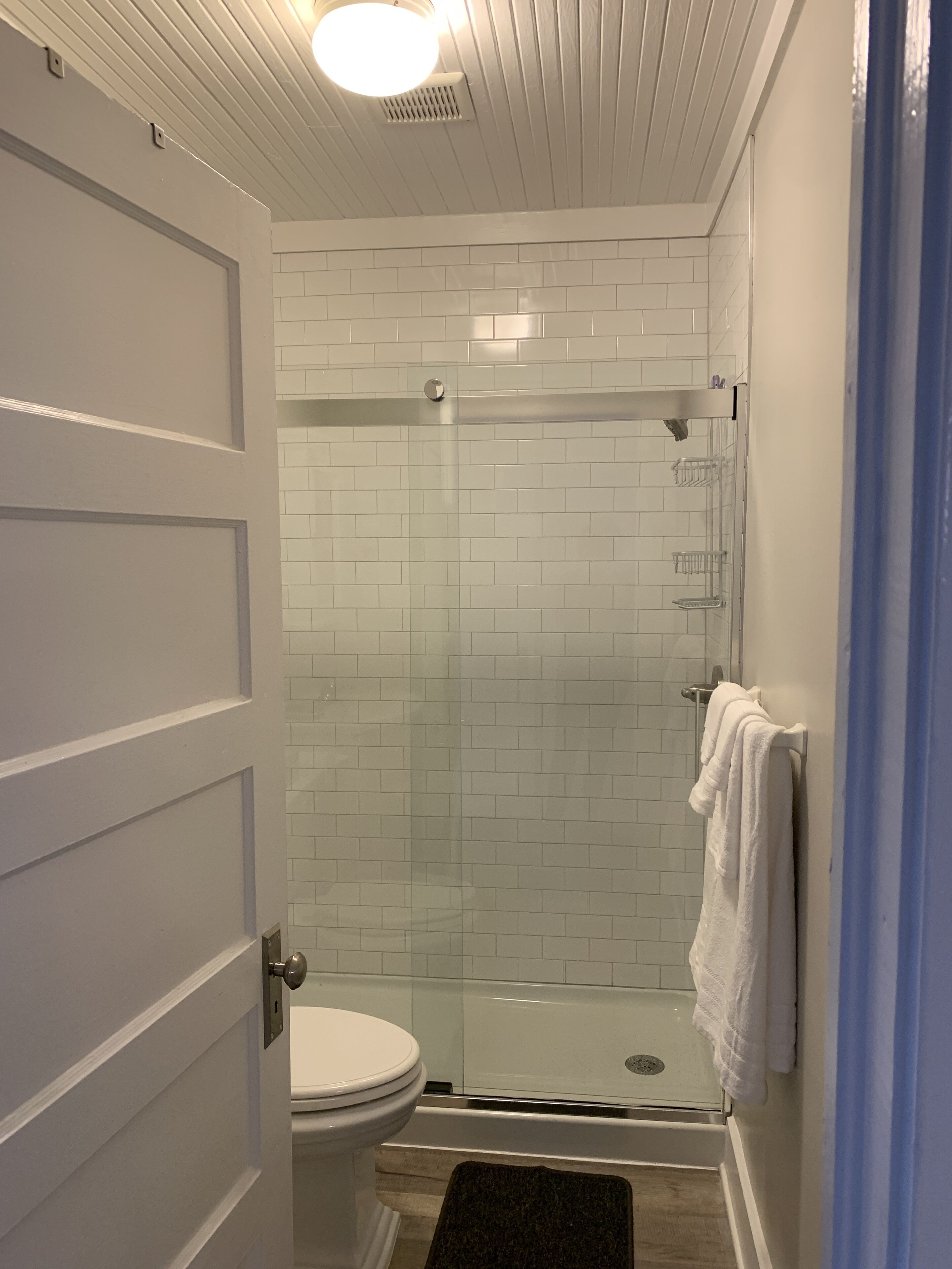 Shower, hair dryer, towels, toilet paper