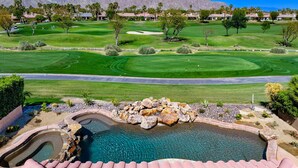A golf course with a pool area in the foreground.