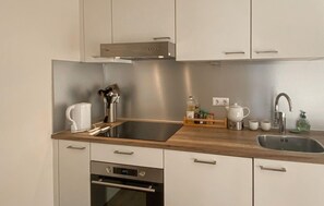 Fridge, stovetop, dishwasher, coffee/tea maker