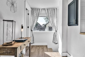 Stroll down this serene hallway to a window with a view of the surrounding residential area.