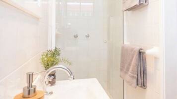 Bathtub, hair dryer, soap, toilet paper