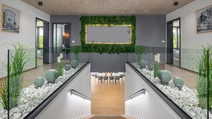 A modern interior with a staircase, a dining area, and a wall decorated with greenery and cacti. - Lovely home in Zminj with sauna (Zminj)