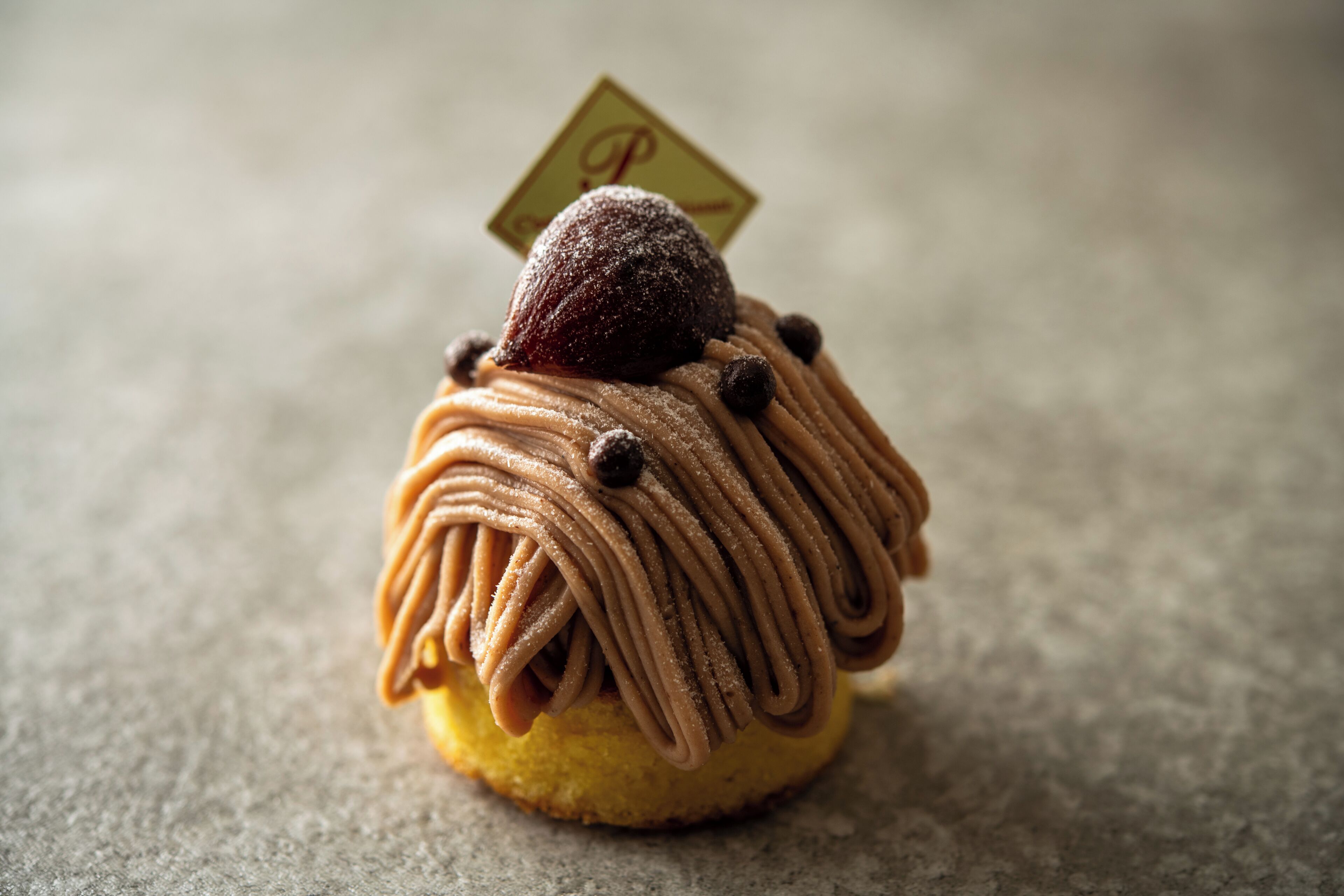 A dessert with a chocolate topping and a small sign on top.