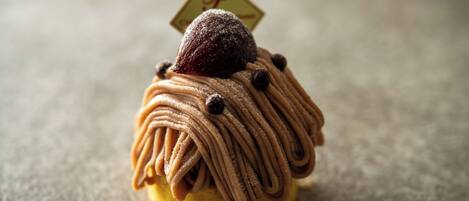 A dessert with a chocolate topping and a small sign on top.