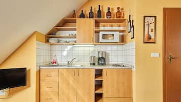 Fridge, microwave, cookware/dishes/utensils, dining tables
