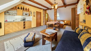 A cozy loft apartment with a kitchen, dining area, and living room. - Chlívce u Hronova by Interhome (Chlivce)