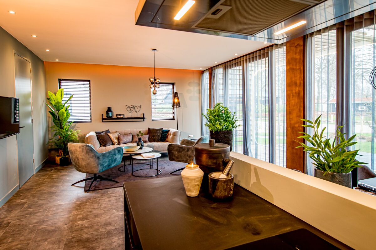 A modern living room with a sofa, coffee table, and decorative items.