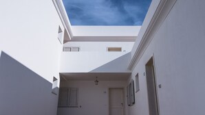 A spacious courtyard with a skylight, a door, and a window.