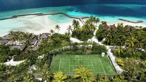 An aerial view of a tropical resort with a tennis court, palm trees, and a beach. - OBLU SELECT Lobigili  with Free Transfers (Lobigili)
