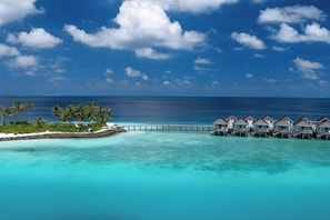 A tropical resort with overwater bungalows connected by a bridge, clear turquoise waters, and palm trees. - OBLU SELECT Lobigili  with Free Transfers (Lobigili)