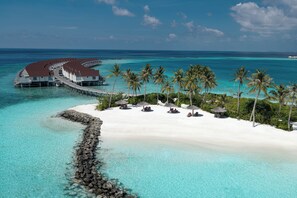An overwater resort with a white sandy beach, clear turquoise waters, and palm trees. - OBLU SELECT Lobigili  with Free Transfers (Lobigili)