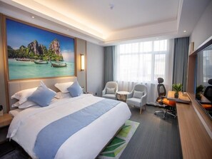 A hotel room with a large bed, two armchairs, a desk, and a large window. - Greentree Eastern Hotel Binzhou Zhonghai International Convention and Exhibition Center (Binzhou)