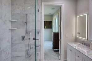 Bathtub, hair dryer, towels, shampoo