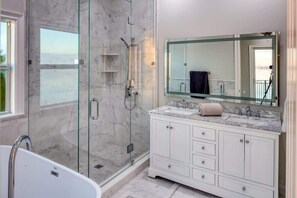 Bathtub, hair dryer, towels, shampoo