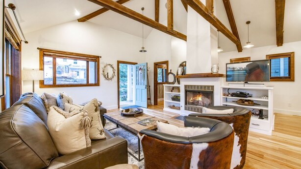 A spacious living room with a fireplace, leather sofa, and a television. - BEST Ski In/Out location in the heart of Park City!  Updated, clean and stocked. (PARK CITY)