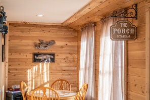 A wooden interior with a sign reading "The Porch Sit & Relax". - Katahdin Comfort - A Beautiful Four Bedroom Home (Millinocket)
