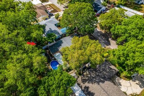 An aerial view of a residential area with houses, trees, and a swimming pool. - Heated Pool, 5BR Sleeps 14, Game Table | 15 Min to Busch Gardens, Tampa (Tampa)