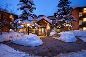 A lodge with a stone facade, a 'Welcome Home' sign, and snow-covered trees. - *7 night stay at Steamboat Springs, CO* (Steamboat Springs)