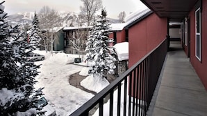 A corridor with a snow-covered landscape, including trees and a building with a red exterior. - *7 night stay at Steamboat Springs, CO* (Steamboat Springs)