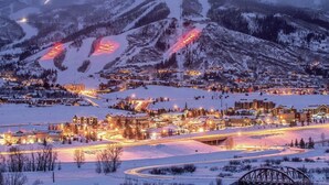 A snow-covered town with illuminated buildings and a bridge. - *7 night stay at Steamboat Springs, CO* (Steamboat Springs)