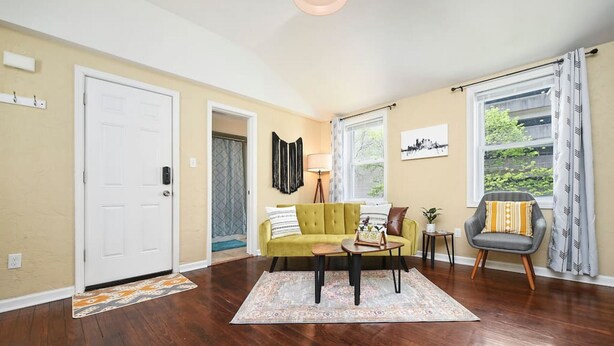 A living room with a green sofa, a coffee table, a lamp, and a chair. - 1210 James St. #2 · Free Off Street Parking! (Pittsburgh)