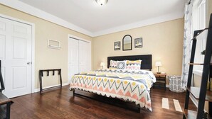 A neatly arranged bedroom with a bed, bedside tables, and a wardrobe. - 1210 James St. #2 · Free Off Street Parking! (Pittsburgh)