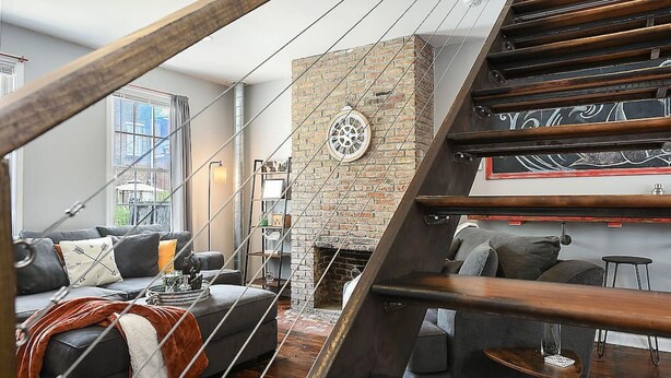 A modern living room with a fireplace, a staircase, and a view of the outdoors. - 1207 Ocala - Boat House - North Side (Pittsburgh)