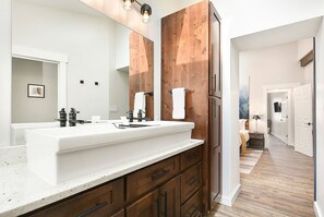 A modern bathroom with a large white sink, wooden vanity, and a large mirror. - 190.5 44th St. - Lawrenceville (Pittsburgh)