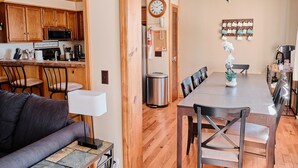 A compact living space with a kitchen, dining area, and a seating area. - Cozy Condo at Summit- 103D (Snowshoe)