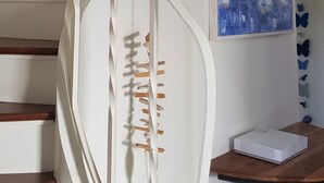 A spiral staircase with white railings and wooden steps.