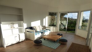 A modern living room with a sofa, coffee table, and storage unit.