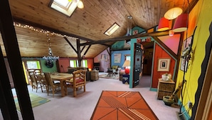 A cozy, multi-level living space with a dining area, a kitchen, and a playroom.